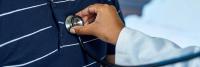 Doctor examining patient with stethoscope